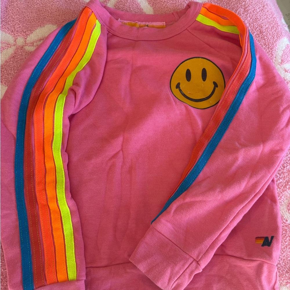 Smiley Face Pink Sweatshirt with Rainbow Stripes